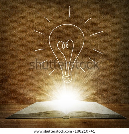 Open book lying on the floor. Above an open book is a sketch bulbs