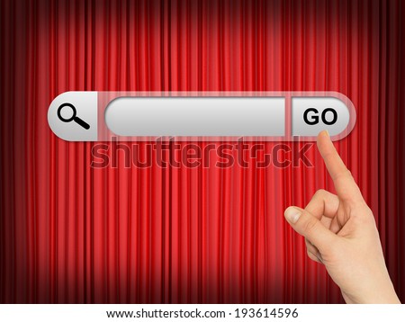 Human hand indicates the search bar in browser. Theater curtain as backdrop
