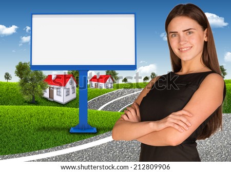 Businesswoman with empty billboard, trees and houses