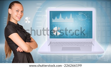 Businesswoman smiling and standing with crossed arms. Open laptop with graphs and graphs with text rows as backdrop