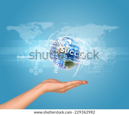 Hand holds Earth with business words. World map as backdrop. Element of this image furnished by NASA