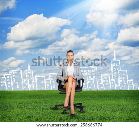 Woman in jacket sits on chair. Background of sketch building, grass, clouds and sun