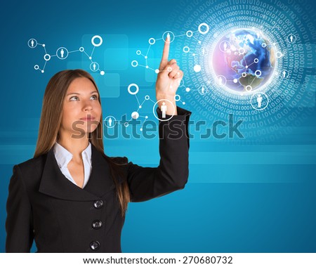 Buinesswoman looking up at her pointer finger of left hand and pressing on holographic screen with connecting lines on world map in foreground. Elements of this image furnished by NASA