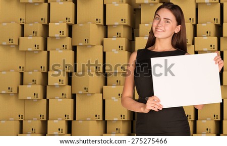 Young businesswoman holding white paper on cardboard boxes set background