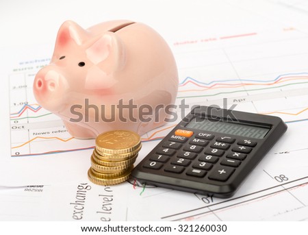 Piggy bank with coins and calculator on business documents background