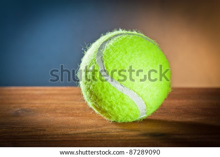 sports equipment .Tennis ball on wood.