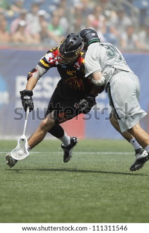 FOXBOROUGH - 28 MAY: Kevin Cooper (41), Maryland, College Park, picks up the ball against Pat Laconi (34), Loyola Maryland, at the NCAA Men\'s Division 1 Lacrosse Championship game, 28 May 2012 in Foxborough, Massachusetts