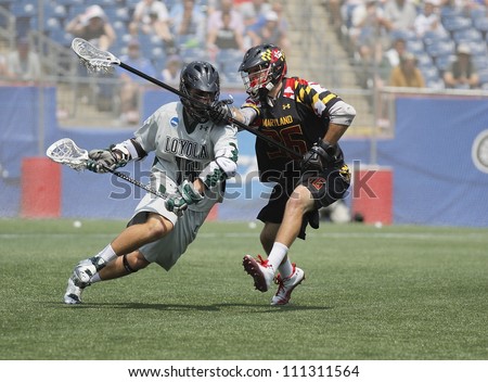 FOXBOROUGH - 28 MAY: Mike Scheeler (15), Loyola, drives to the net against Jesse Bernhardt (36), Maryland, College Park, at the NCAA Men\'s Division 1 Lacrosse Championship game, 28 May 2012 in Foxborough, Massachusetts
