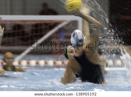 BOSTON - 12 MAY: A water polo player takes a shot on goal at a NCAA Women\'s Division 1 Water Polo game in Boston, Massachusetts, 12 May 2013