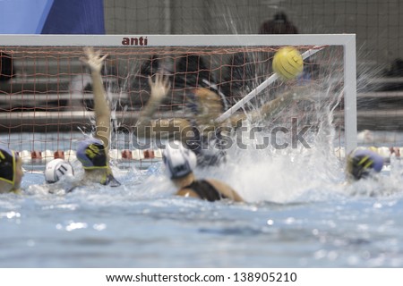 BOSTON - 12 MAY: A water polo player watches a shot on goal at a NCAA Women\'s Division 1 Water Polo game in Boston, Massachusetts, 12 May 2013