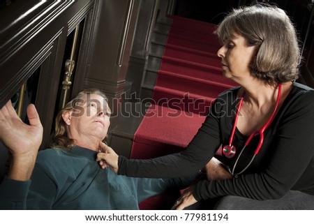 Woman checking pulse of passed out man