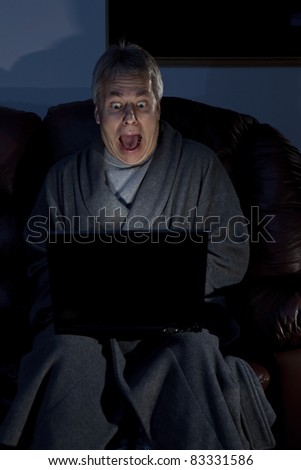 Man in housecoat working late series shocked computer crash