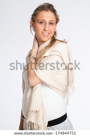 Young woman at the early stages of pregnancy, wearing a shawl