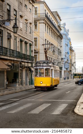 Vintage yellow tramway in the streets of Lisbon