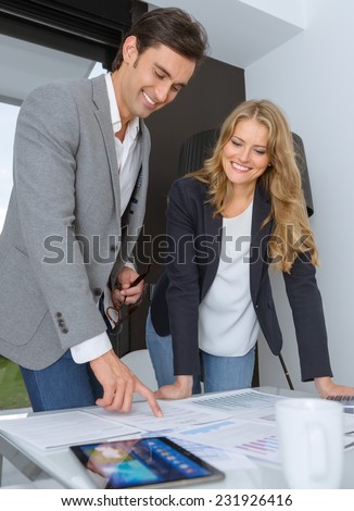 Man and woman in casual business clothes discussing business plan