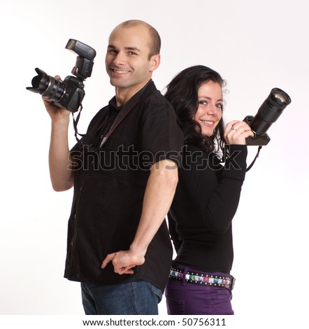 Portrait of a couple of cheerful photographers back to back