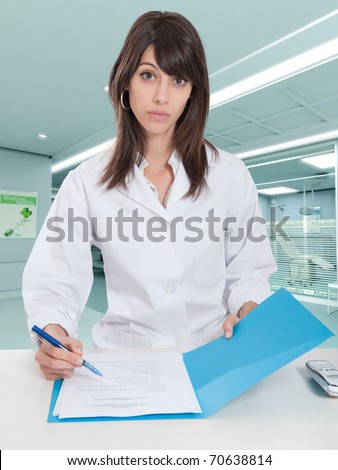 Young female hospital administrative in a desk at the hospital hall