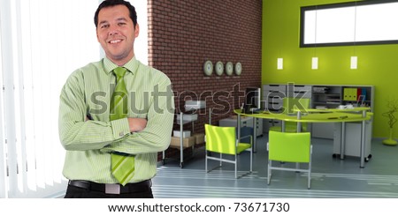 Business man standing in an office in green shades