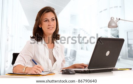 Woman sitting at her desk on an office environment