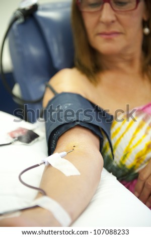 Woman donating blood, plasma, supporting the emergency supplies in hospitals.