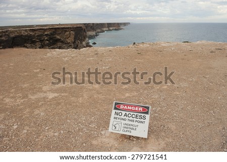 Danger warning sign at scenic lookout Great Southern Ocean cliff Nullarbor Plain Australia, view to horizon, copy space.