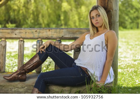 Young woman sitting outside in white shirt and jeans