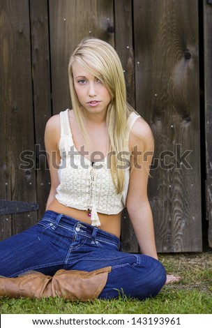 young teen girl posing in boots and low rise jeans
