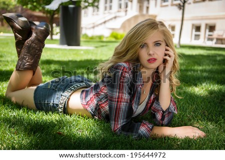 Young girl posing and laying wearing flannel shirt and boots