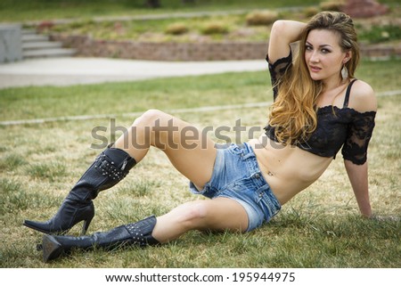 Female model in black top and tight cut off jeans