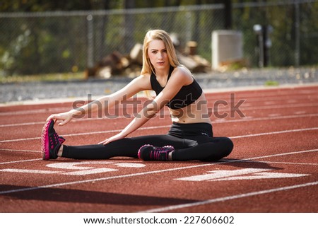 Young fit girl getting ready to run on the track