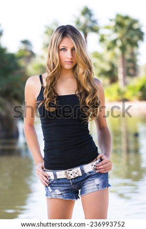 Young sensual beauty queen posing outdoors in summer wear