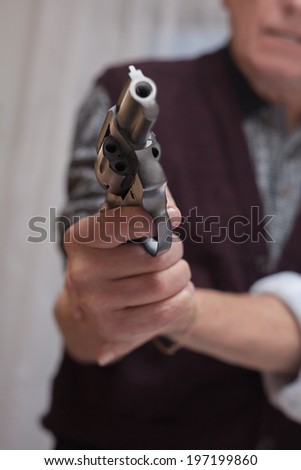Closeup of senior couple fighting with a gun.