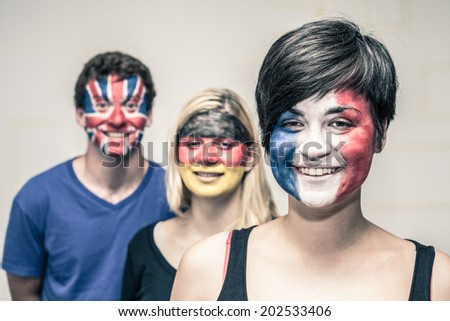 Group of happy people with painted flags on their faces.