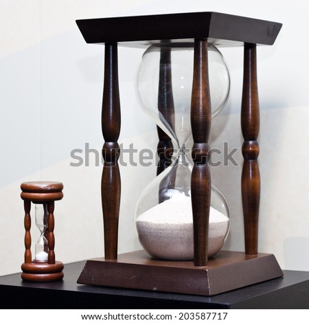 Two old antique wooden sand clock. Big and small sand clock.