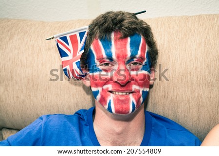 Portrait of funny man with British flag painted on his face.