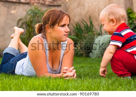 Mother with toddler serious moment in the garden.