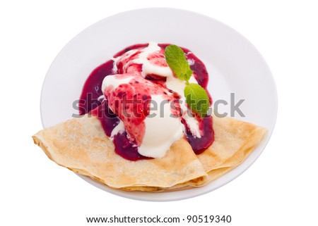 Crepe with ice cream and berry topping, isolated on white background.