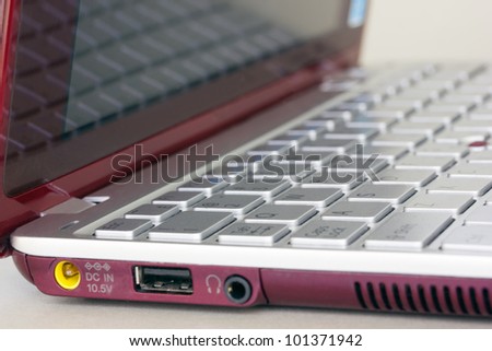 modern red small netbook with gray keyboard