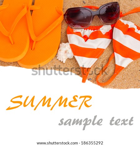orange sandals and swimming siut on sand border  isolated on white background