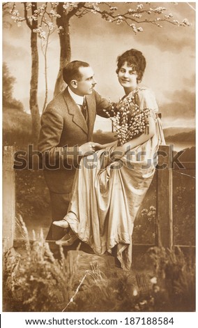 POLAND, WARSAW - CIRCA 1924 : old photo  of happy young romantic couple of woman and man in spring garden. Illustrative Image, subject of human interest