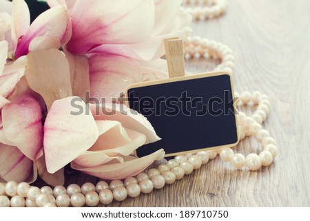 weding greetings  - magnolia flowers and pearls with copy space on chalk board