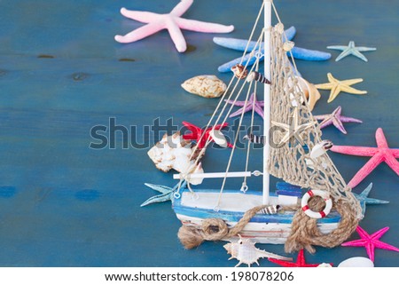Marine life with seashells,  starfish and boat , copy space on blue background