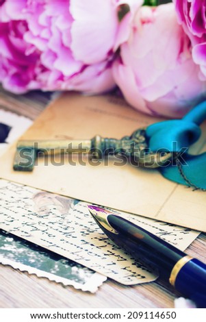 old golden quill pen and antique letters with peonies flowers and key