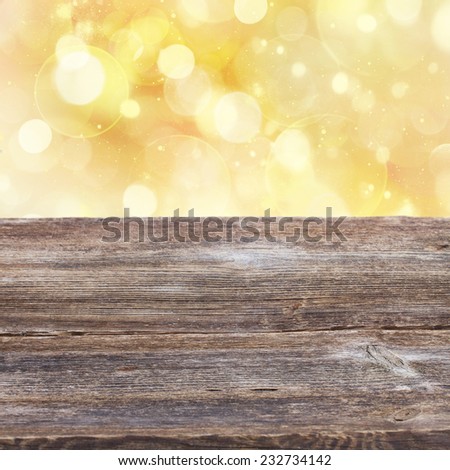 empty old wooden table with golden sparkles  background