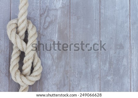 marine knot on wooden background with copy space