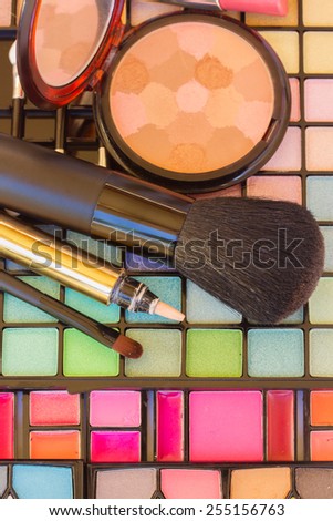 decorative make up cosmetics with powder and brushes