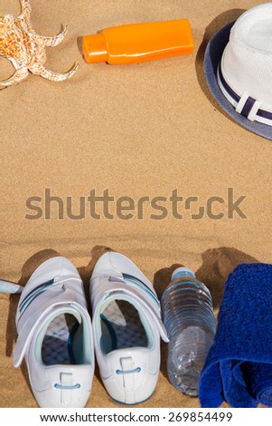 white sneakers in sabs with bottle of water and hat, top view