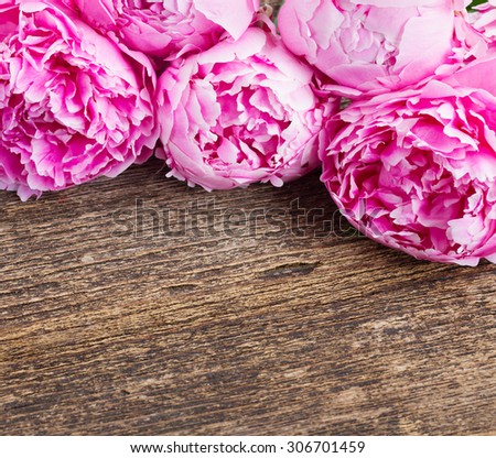 bouquet  of fresh pink  peonies on wooden background with copy space