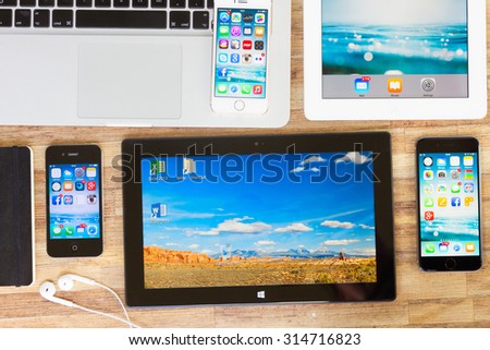 WARSZAWA, POLAND - MAY 13, 2015. Microsoft tablet with frame of Apple Iphones 6, iphone 5s, ihone 4s , ipad and macbook