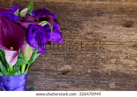Bouquet of calla lilly and eustoma flowers  on wooden table